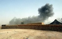 Smoke rises from a house in Tine on the 